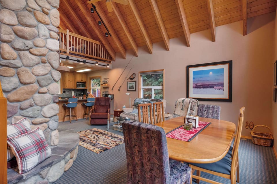 The dining room boasts a spacious table and a warm, inviting setting, perfect for relaxed meals.