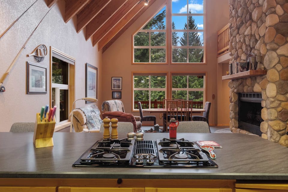 Cook with a view! This kitchen features a beautiful green landscape outside, adding a touch of tranquility to your culinary creations.