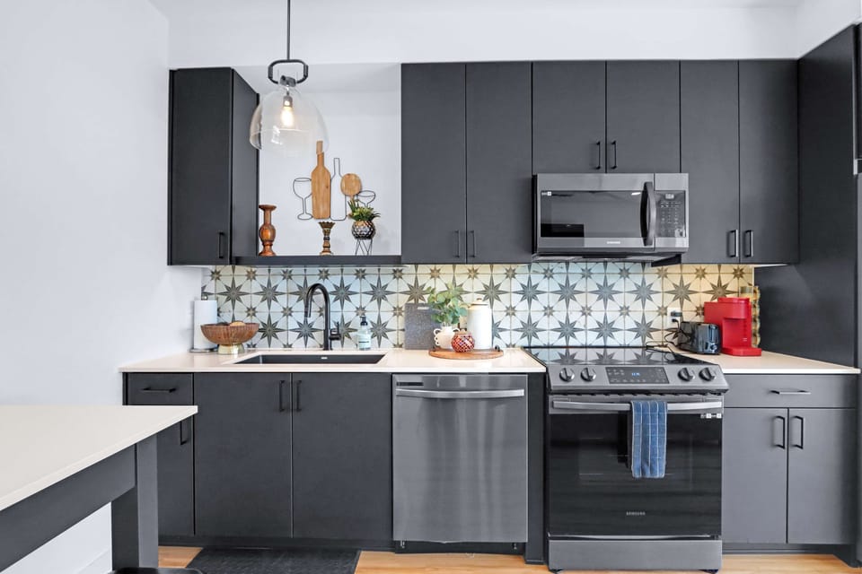 The chic, open kitchen offers ample space & all the comforts of home