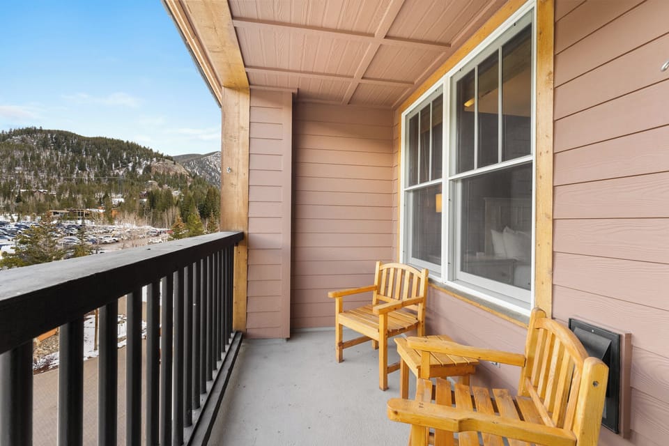 Relax on your private balcony with stunning mountain views, where cozy wooden chairs invite you to unwind with morning coffee or evening cocktails.