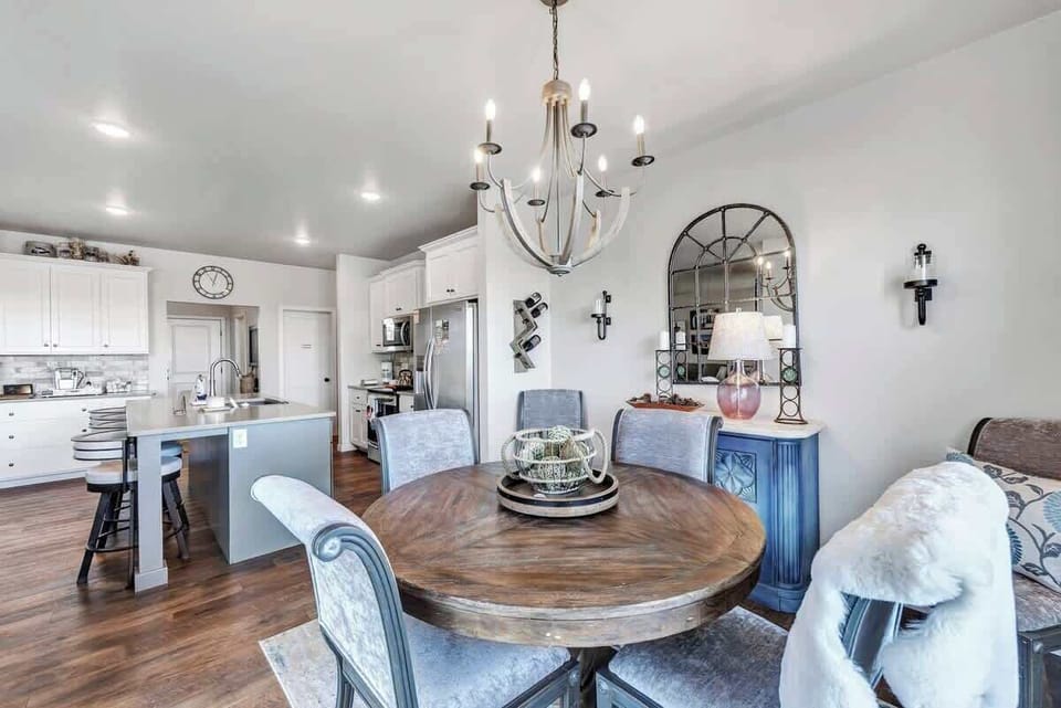 Fully equipped kitchen with pots/pans, utensils, place setting for 5 to 6 people, and modern appliances