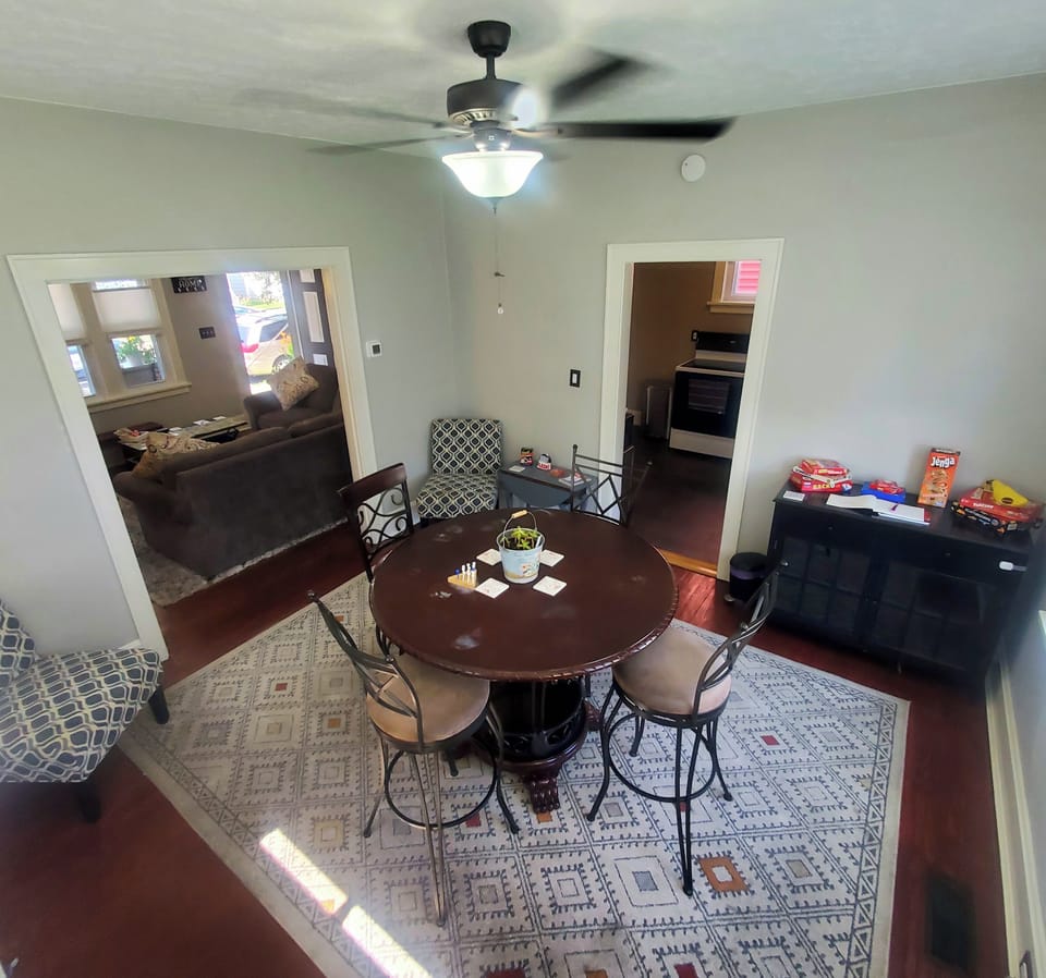 High-Top Table & Chairs, Games, Hardwood Floors, Rug and Room-Darkening Blinds