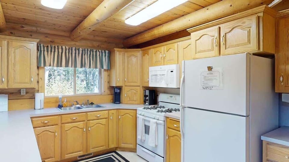 Kitchen equipped with appliances, pots and pans, dishes, utensils, and basic cooking essentials.
