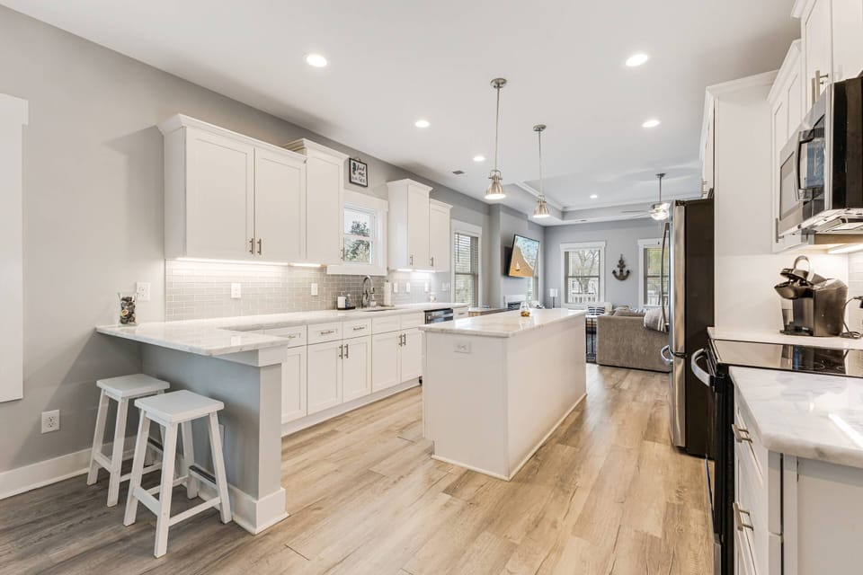 Spacious kitchen with ample counter space, complete appliances, and a breakfast bar with seating for 2.