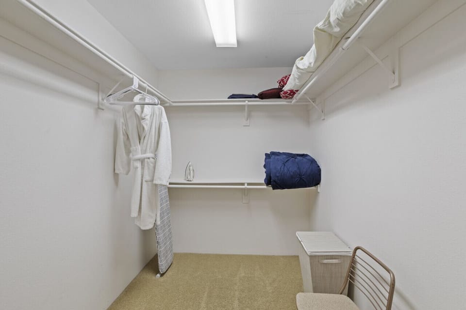 Spacious walk-in closet w/ open shelving & plenty of room for storage