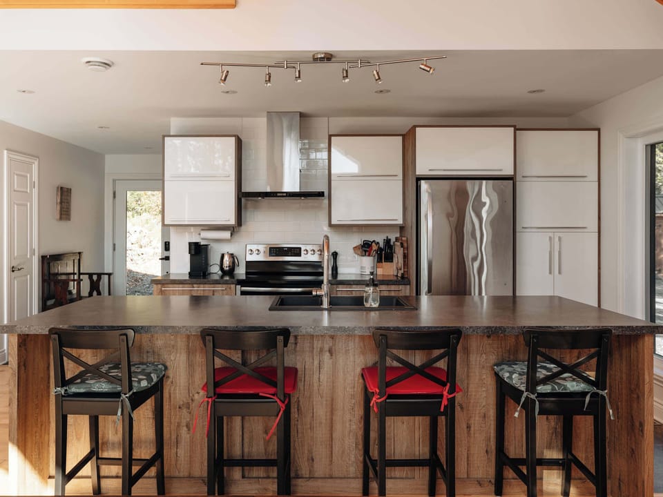Kitchen island with seating and view of main living area