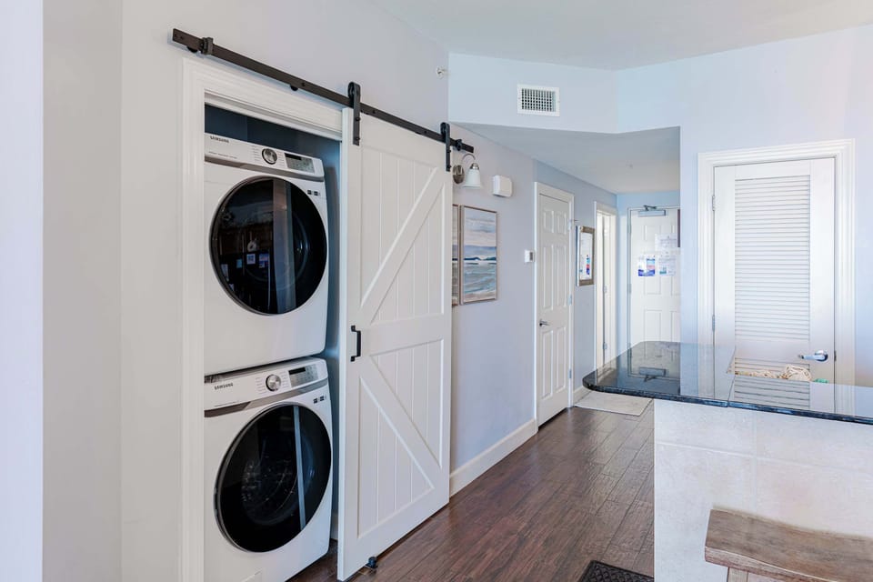 Private laundry is available for your stay, tucked away by the kitchen area
