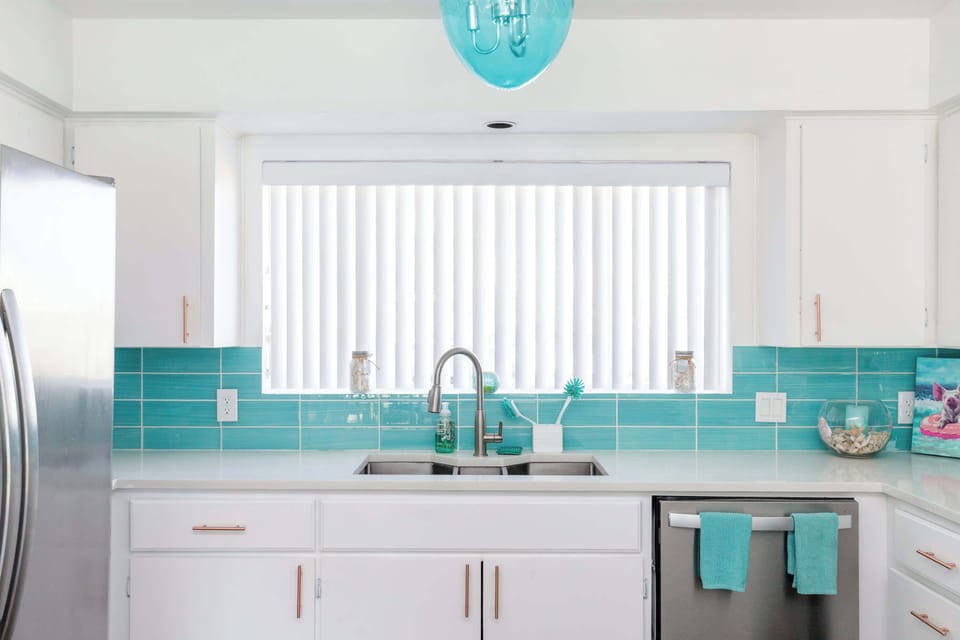 The beachy kitchen offers ample storage space & all the comforts of home