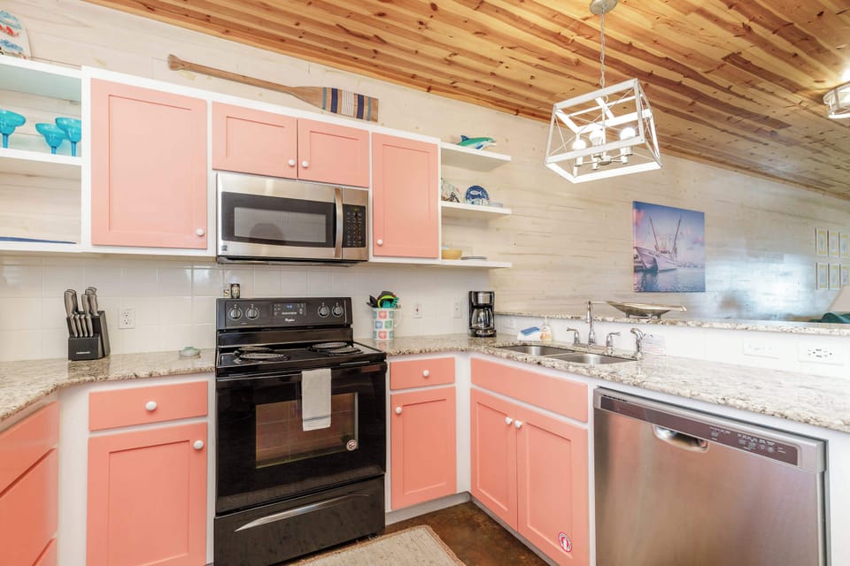 The colorful coastal kitchen offers ample space & all the comforts of home