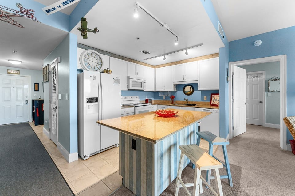 modern kitchen with a central island and light blue walls