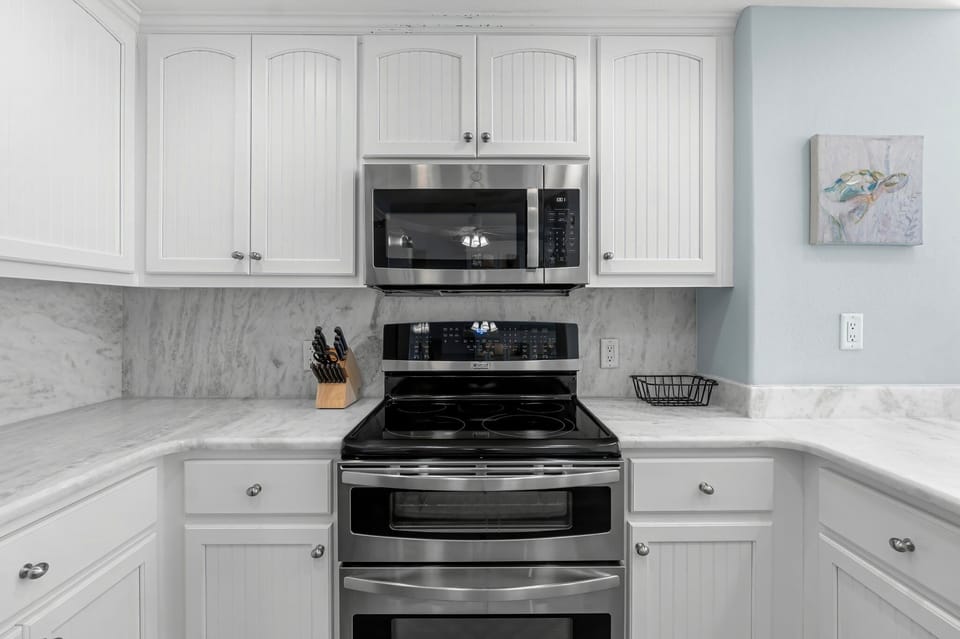 Modern kitchen with stainless steel appliances and white cabinetry