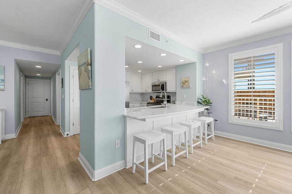 Modern kitchen with a breakfast bar and natural light from large windows