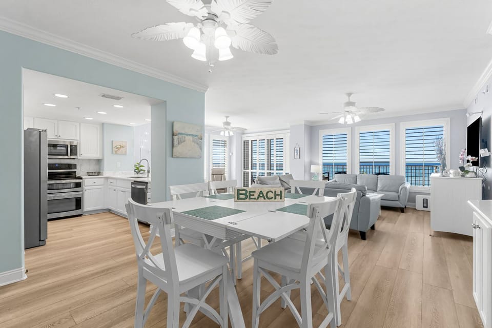 Open-concept dining and living area with ocean views and modern coastal decor