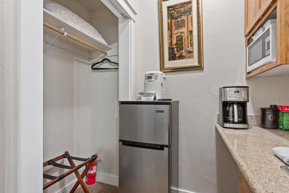 Kitchenette with refrigerator, microwave, and coffee maker