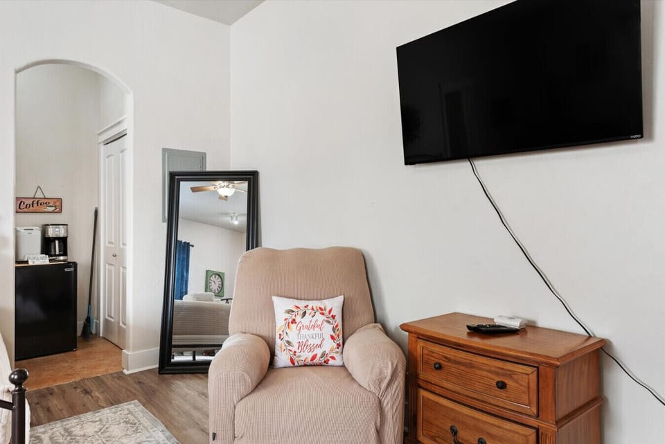 Cozy chair perfect for reading and a large new smart TV
