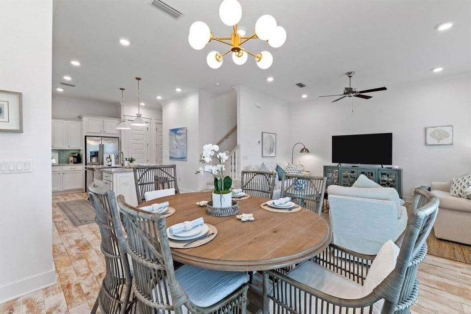 A stylish dining space with comfortable seating, a chic chandelier, and an inviting atmosphere for shared meals.