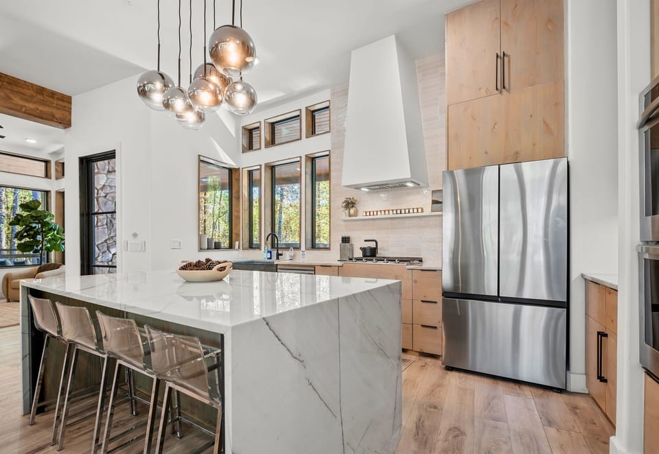 Gather around the central island for casual meals, morning coffee, or a quick chat with friends. This setup invites everyone to come together in the heart of the home.