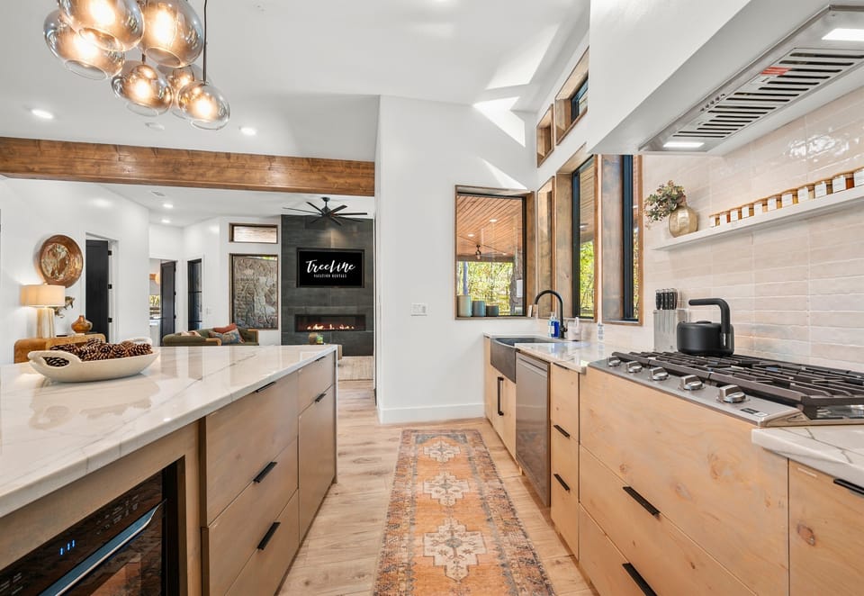 Light-filled and spacious, this kitchen perfectly balances function and style. The warm wood and modern fixtures make it a cozy, inviting place to create and connect.