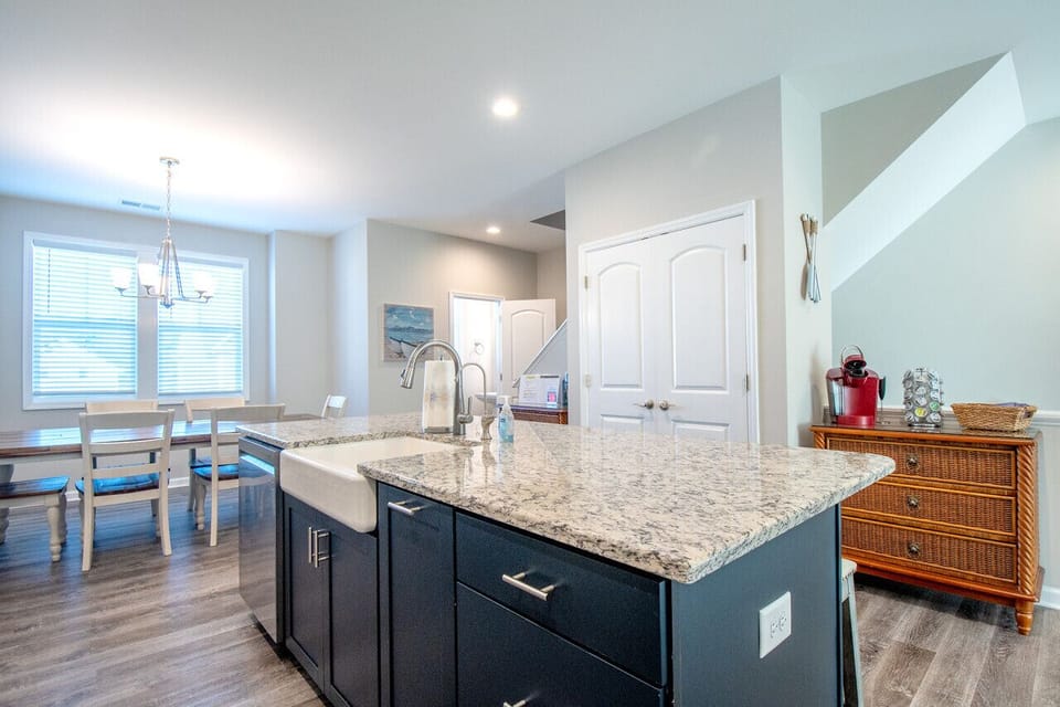 Open-concept kitchen and dining area with large island and modern finishes
