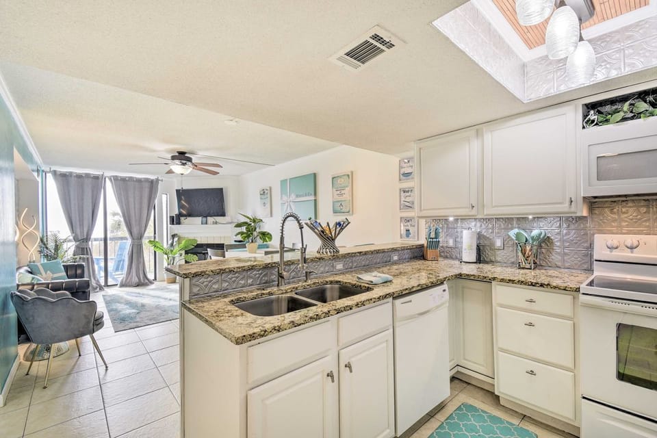 View of the kitchen and living/dining area with bright, open space for gathering