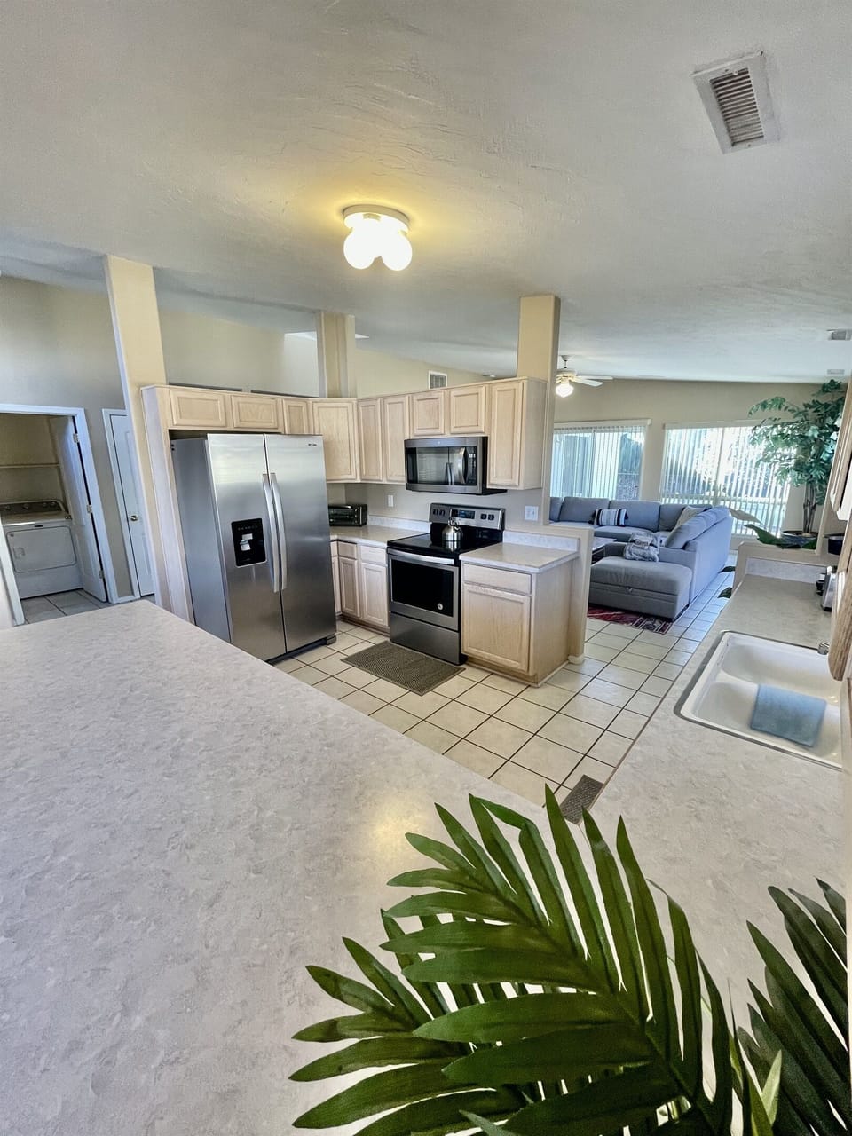 The spacious kitchen boasts ample counter space, stainless steel appliances, and all the essentials you need to whip up a gourmet meal with ease.