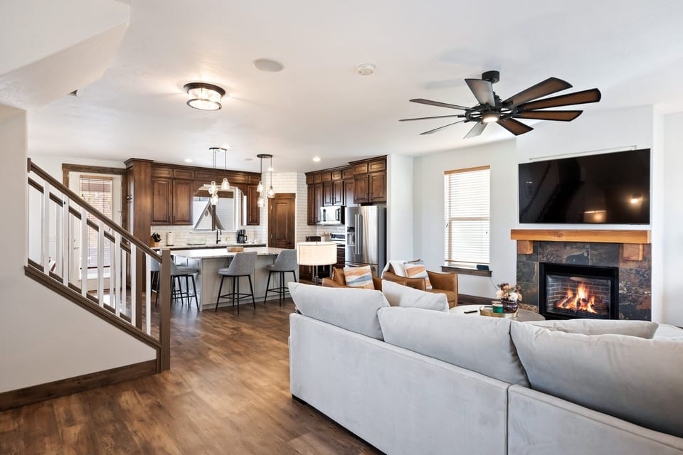 - Open living area with fireplace and modern kitchen views  
- Large sectional sofa and dining space for group gatherings  
- Perfect for entertaining or relaxing after outdoor fun