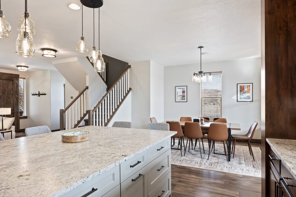 - Kitchen island with drawers and pendant lights above  
- Spacious open flow to dining and living areas  
- Perfect gathering space for cooking and conversation
