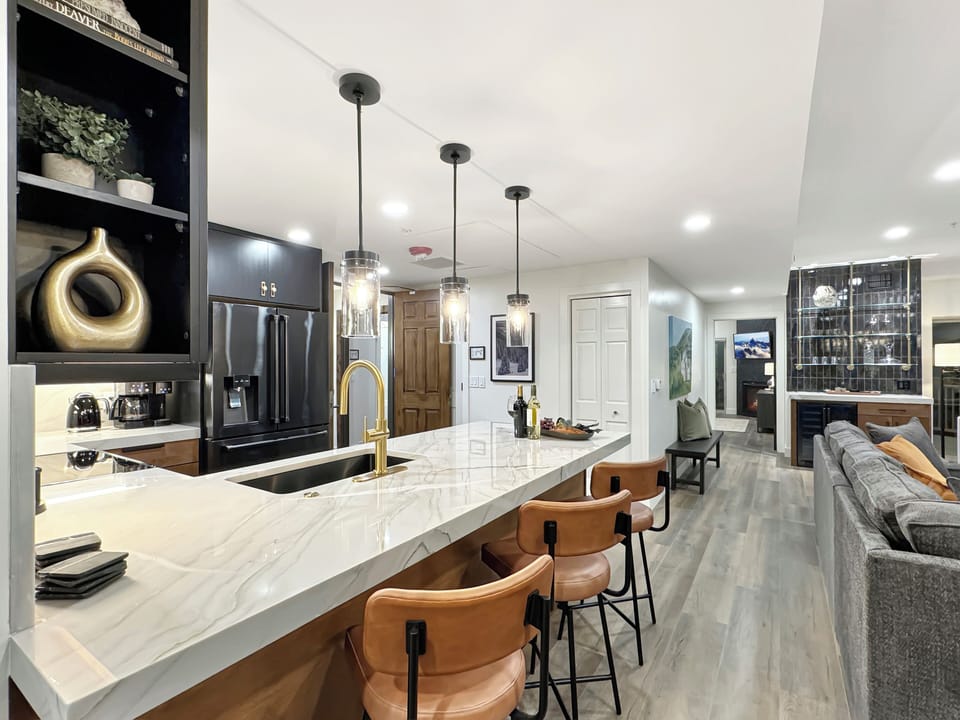 Enjoy seating for three at the kitchen island bar, conveniently located near the guest master bedroom.