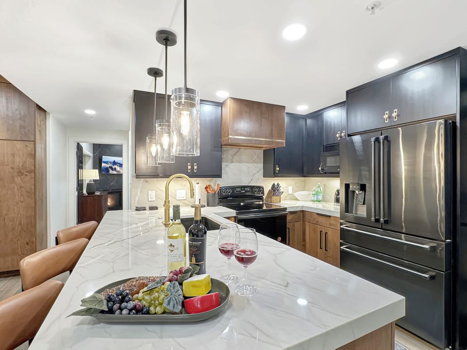 The kitchen is fully equipped for all your cooking needs and features a bar with seating for three.