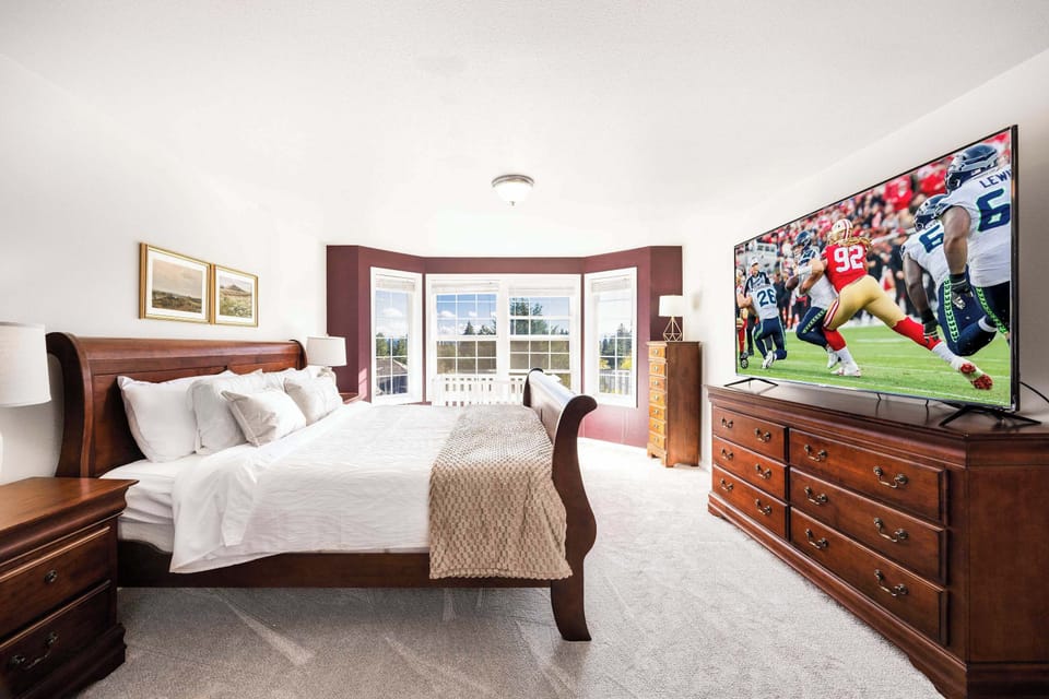 The master bedroom with a king size bed and a baby crib