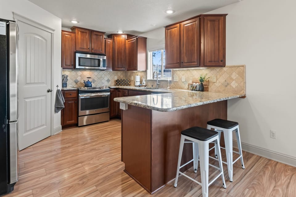 Whip up your favorite meals in this fully equipped kitchen, complete with a bar for extra seating—perfect for chatting while you cook or enjoying a quick bite!