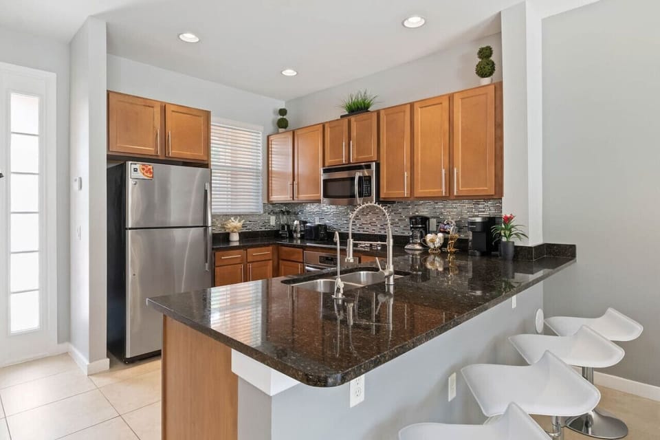 Fully equipped kitchen with granite countertops, stainless steal appliances, and bar areas#Disney #Parks #kingdom #springs #RegalOaks #resort #Apartment #Vacation #Rental #waterpark #Kissimmee #Orlando #universal #citywalk
