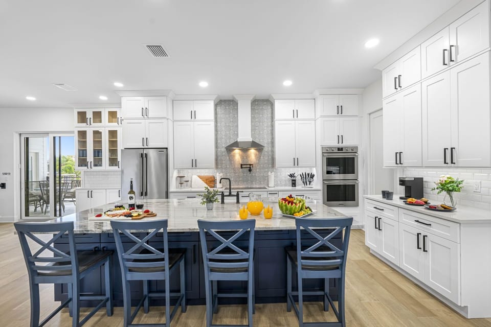 Around the counter, comfortable barstools with supportive backs invite guests to sit and linger.