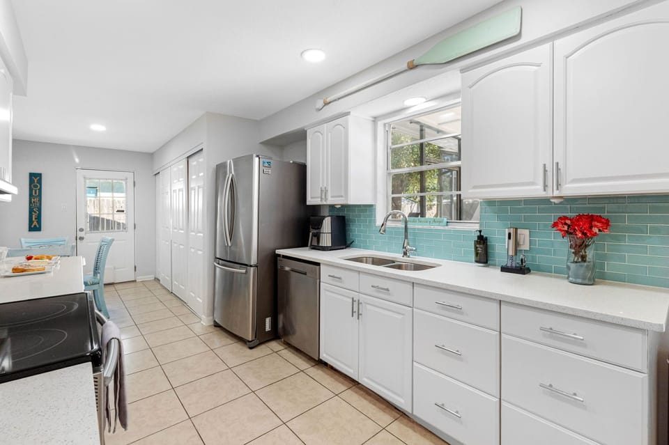 The heart of the home, the kitchen, is a bright and inviting space, fully stocked with all the essential appliances you'll need to create delicious meals throughout your stay.