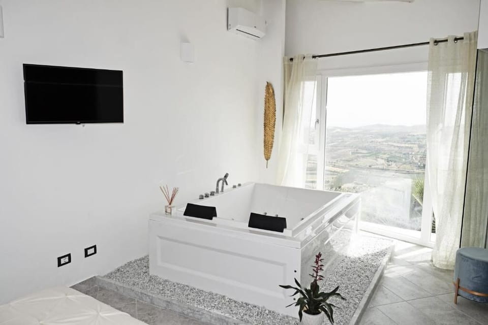 Luxury Room, Hot Tub, Partial Sea View | Pillowtop beds, in-room safe, soundproofing, iron/ironing board