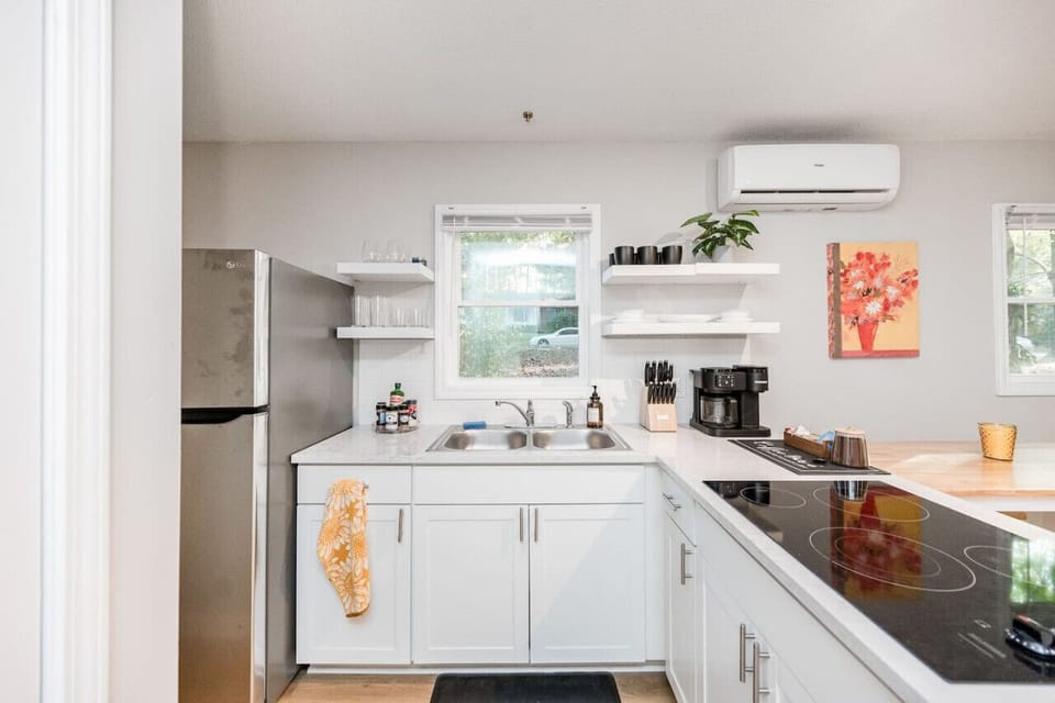 Cook in your fully stocked kitchen which includes pots, pans, and other essentials.  Please note there`s no oven, but you have an air frying toaster oven (not pictured) to the right of the fridge which fits a 12` pizza or easily heats up leftovers..