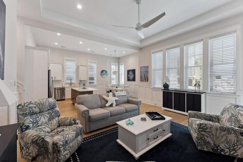Open Living, Dining & Kitchen Area with Coastal Accents & Natural Light