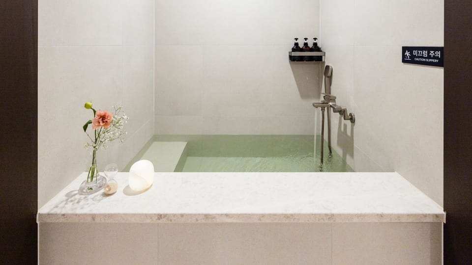 Deluxe A | Bathroom | Hair dryer, slippers, towels, soap