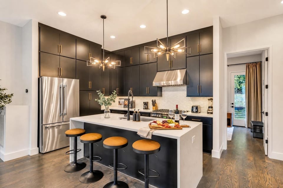 The kitchen island is where everyone gravitates: cook, pour, chat, and snack from the same spot while food prep happens without anyone getting left out