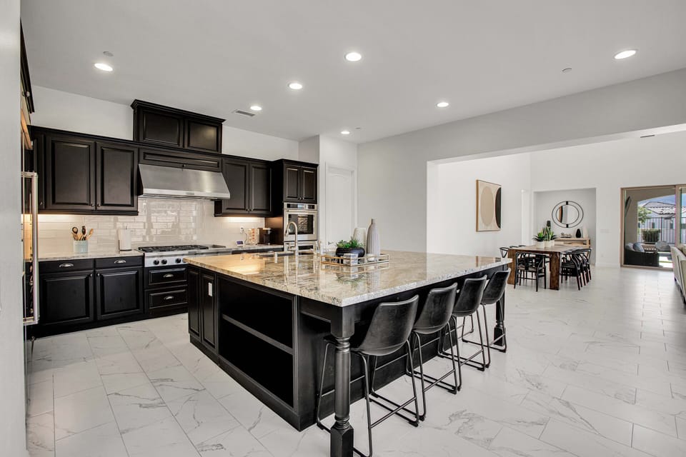 Expansive chef's kitchen with oversized island and bar seating