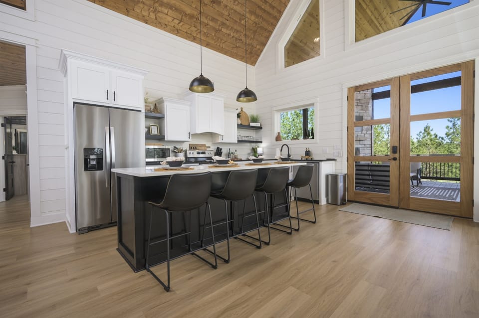 A chef’s paradise with sleek black countertops and stainless steel appliances.