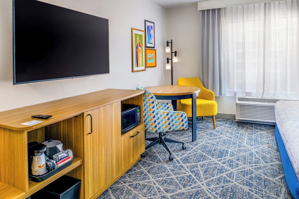 Premium bedding, desk, laptop workspace, blackout drapes