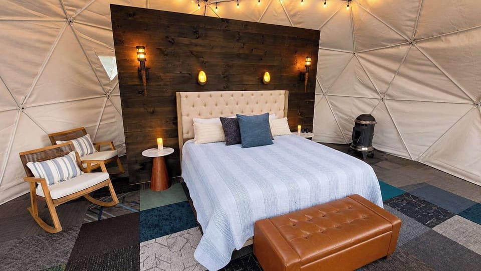 King-bed dome with pellet stove and warm interior lighting
