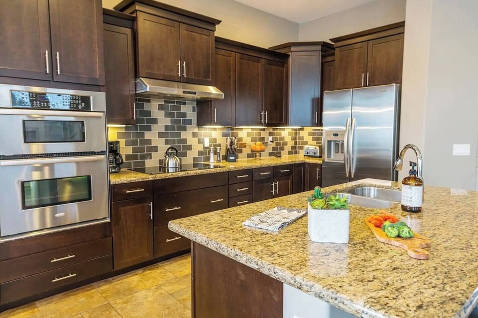 Modern kitchen with an induction stove and all essential appliances for your culinary needs.