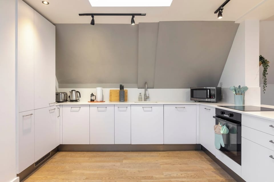 Fully equipped kitchen, microwave, kettle, toaster, induction cooker and oven.