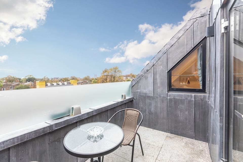 Primary balcony with table and 2 chairs
