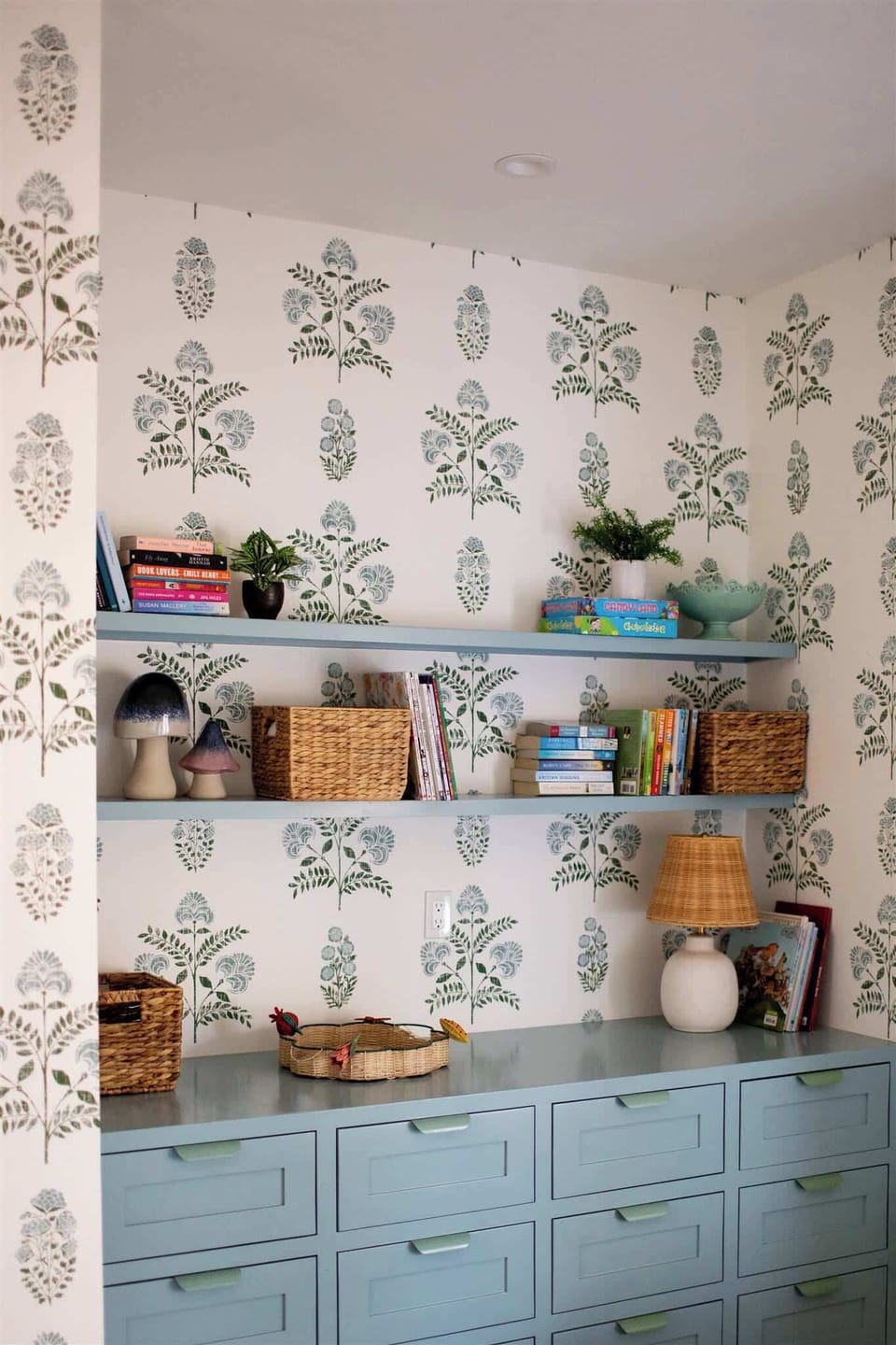 A charming corner awaits, with a cabinet full of books and board games to keep everyone entertained.