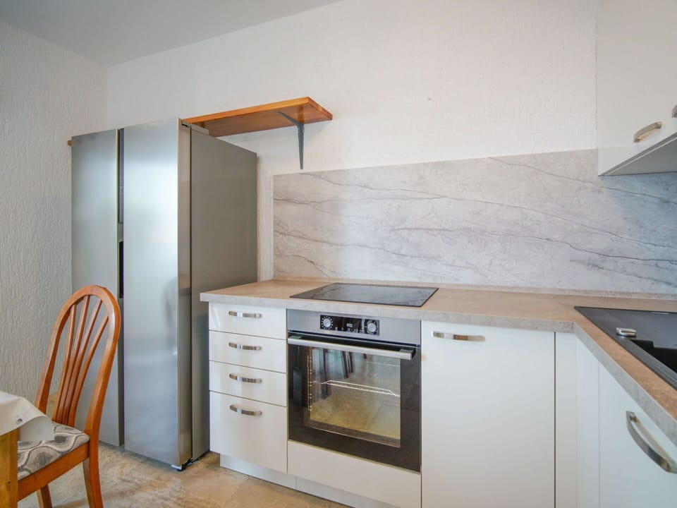 Flooring, Countertop, Wood, Kitchen, Kitchen Appliance, Cabinetry, Floor, Furniture, Major Appliance, Interior Design