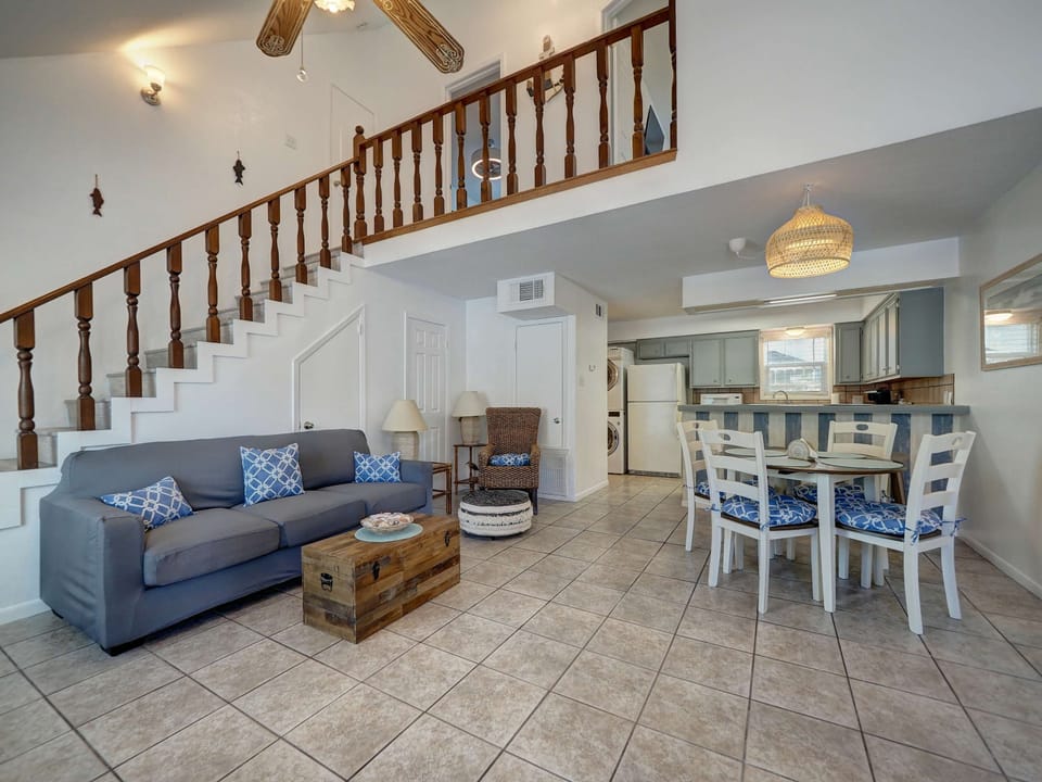 Our living room boasts soaring ceilings and an open floor plan, creating a bright, welcoming space perfect for gatherings.