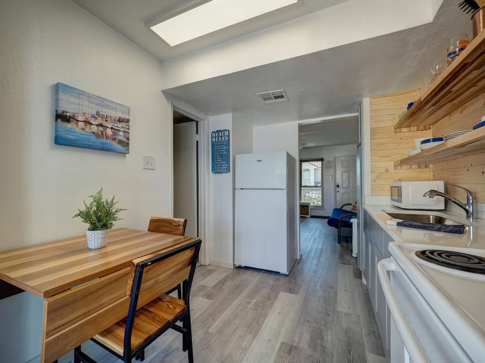 Prepare meals and enjoy them right at the cozy dining table beside it—a perfect setup for togetherness.